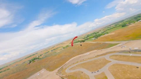 Chasing the skydiver in his parachute with the drone. Video stock 284726003