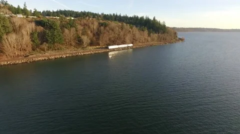Chasing Sound Transit Train on shoreline of Puget Sound Seattle Washington Stock Footage 60114261