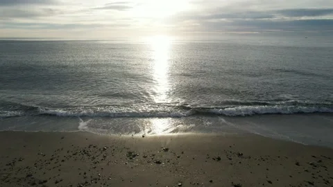 Chasing the sun by flying low and fast from the beach and then out to sea Stock Footage 232984841