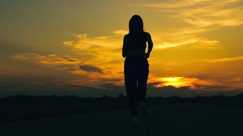 Chasing sun. Training jogging. Running outside city, girl runner breathing in Stock Footage 316793807