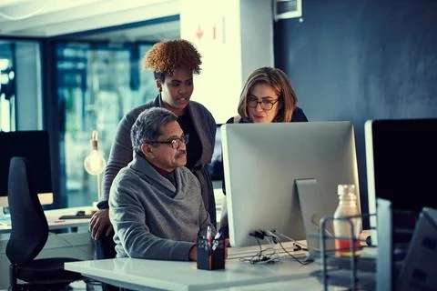 Chasing their deadlines through the night. a group of businesspeople working Stock Photos