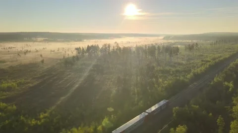 Chasing Train with Drone on Sunrise Stock-Footage 138459743