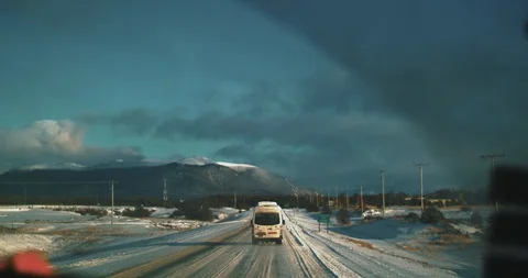 Chasing a van through a snowy mountain road. Stock Footage 129847262