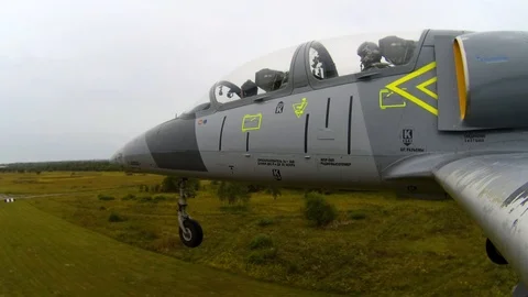 Chassis of training fighter plane is touching the ground. View from left wing. Video stock 118677090