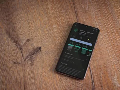 Chat AI app play store page on smartphone on wooden background Foto stock