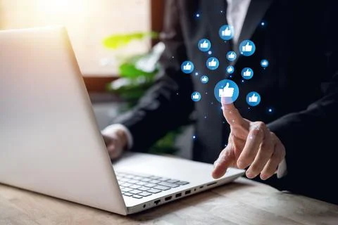 Chat and notification on notebook with blue like emoji social media icon. b.. Stock Photos