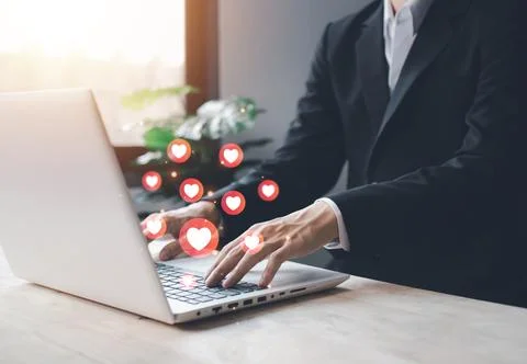 Chat and notification on notebook with red heart emoji social media icon. b.. Stock Photos