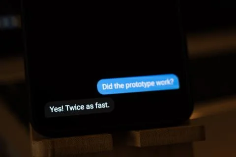Chat on a smartphone asking Did the prototype work, answered Yes, twice as fast, Stock Photos