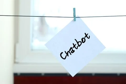 Chatbot. Note is written on a white sticker that hangs with a clothespin on a Stock Photos