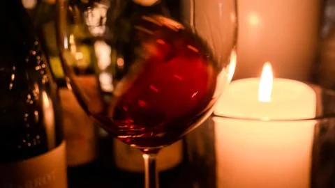 Chateauneuf du Pape Red wine swirling in romantic candle light glass 1 Foto stock