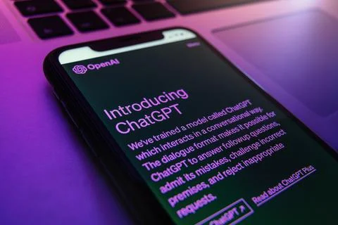 ChatGPT chatbot, powered by Open AI, is displayed on smartphone in neon light Stock Photos