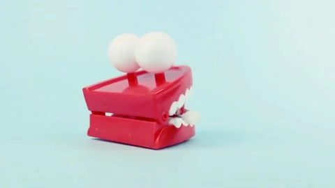 Chattering teeth on blue background Stock Footage 172563454