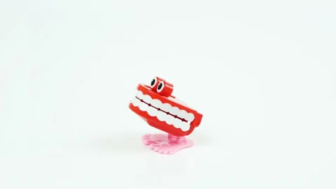 Chattering teeth toy stops in the middle, white background Video stock 134313920