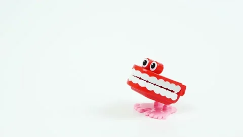Chattering teeth toy stops on the side, white background Stock Footage 134313913