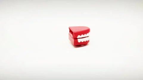 Chattering Teeth Toy Walking on White Background Stock Footage 32219216