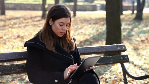 Chatting on a tablet in the park Stock Footage 69832619