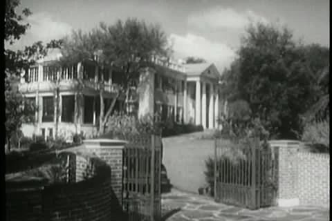 Chauffer in vintage car pulling up to front of mansion Video stock 11356555