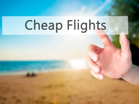 Cheap Flights - Hand pressing a button on blurred background concept on visua Stock Photos