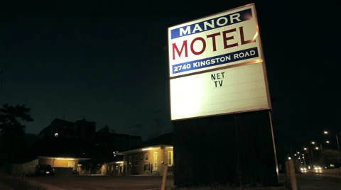 Cheap motel Exterior late evening with sign Stock Footage