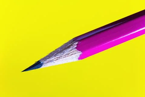 Cheap sharp sharpened pencil on a yellow background. Foto stock
