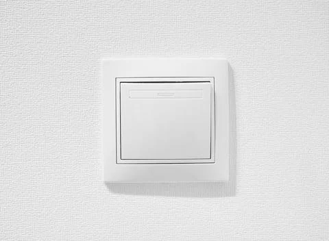 Cheap simple single-pole light switch. Inexpensive plastic push button switch Stock Photos