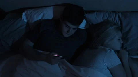 Cheating husband phone bed sleeping wife night Stock Footage 149035863
