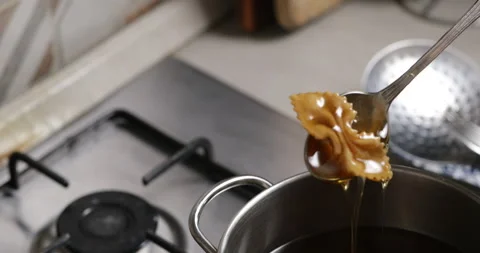Chebakia being dipped in syrup Stock Footage 236489903
