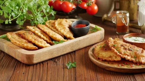 Chebureki with sauce. Presentation of the dish. Camera drive along the dish.  Stock Footage 147869956