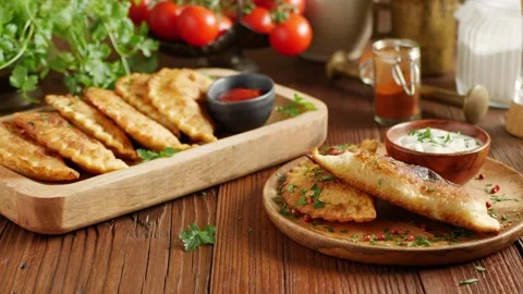 Chebureki with sauce. Presentation of the dish. Camera drive along the dish.  Stock Footage 147870115