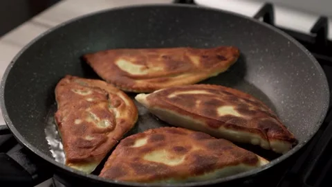 Chebureks are fried in a pan. Stock Footage 153805694