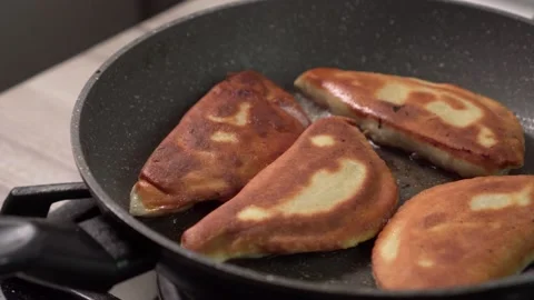 Chebureks are fried in a pan. Stock Footage 153973017