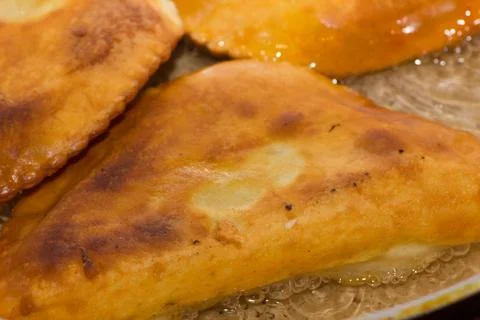 Chebureks fried in a pan 写真素材