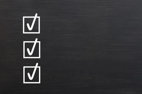 Check boxes with ticks on a blackboard background Foto stock