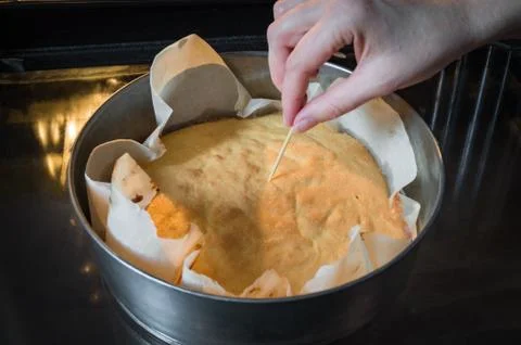 Check a cake for doneness Stock Photos