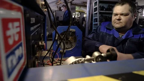 Check the car generator. The worker attaches the clamps to the generator. Test Video stock 75134640
