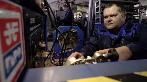 Check the car generator. The worker attaches the clamps to the generator. Test Stock Footage 75249061