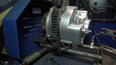 Check the car generator. The worker attaches the clamps to the generator. Test Video stock 75328232