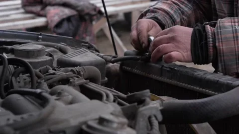 Check car radiator. Hand open the radiator antifreeze tank in the car engine. Stock Footage 182788258