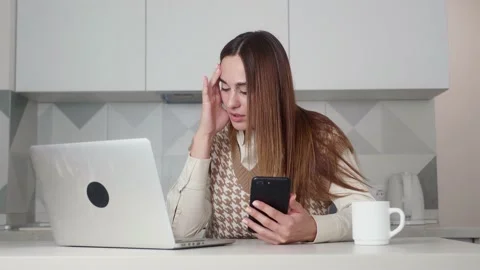 Check data from phone to computer. Girl discovered an error in her calculations Stock Footage 171474340