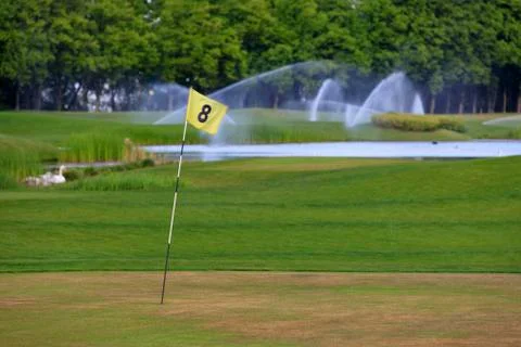 A check mark on the golf course marks another hole. Stock Photos