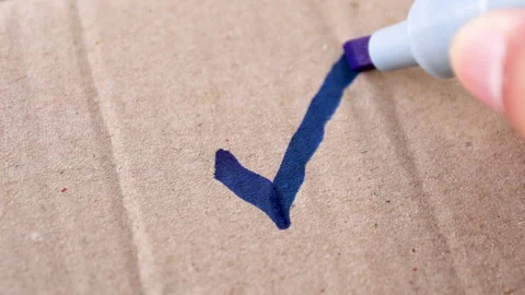 Check mark, tick, a hand drawing a check mark with a blue marker Stock Footage 328232607