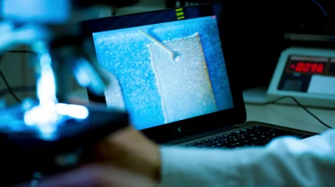 Check micro electronic chip under a microscope Stock Footage 38602696