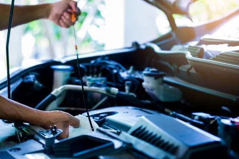 Check the oil level in car engine. Mechanic checking car engine or vehicle Stock Photos