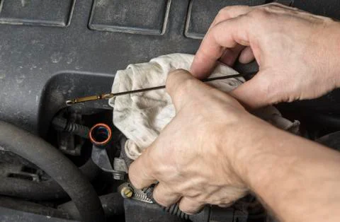 Check oil level at dipstick mark in car engine Stock Photos