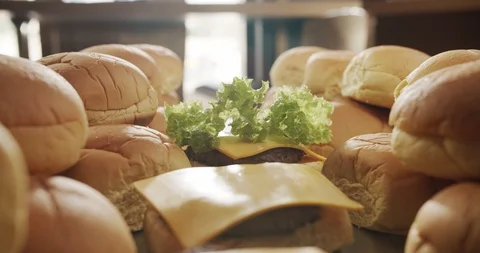 Check out the camera, male hand lays lettuce leaf on burger. 4K Slow Motion Stock Footage 117587309