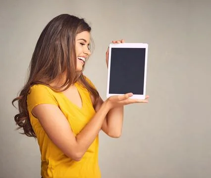 Check out this tutorial. an attractive young woman holding a digital tablet with Stock Photos