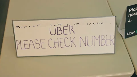 Check out with Uber - Order on Uber Eats Signage at Restaurant Stock Footage 147844272