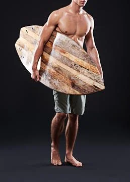 Off to check out the waves. Cropped s.tudio shot of a young surfer with a Stock Photos