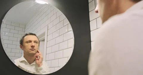 Check the smoothness of the shave, a man examines his skin on his face after 스톡 동영상 264019537
