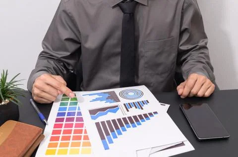 Check the staff report documents the growth of the business. At the desk Stock Photos